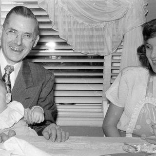 Man, baby, woman at table