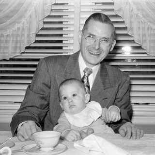 Man, baby, woman at table