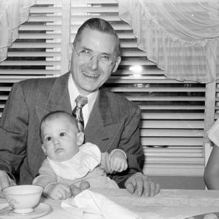 Man, baby, woman at table
