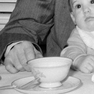 Man, baby, woman at table