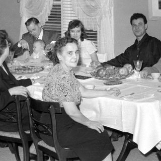 Family dinner scene, mid-20th century
