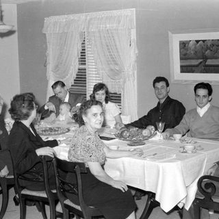 Family dinner scene, mid-20th century
