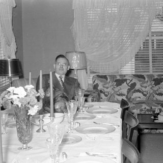 formal dining table with seated man