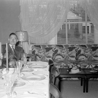 formal dining table with seated man