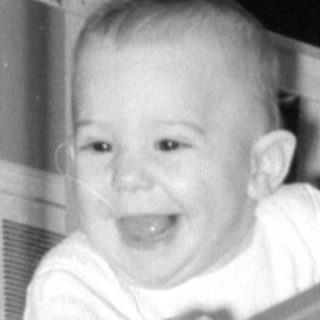 Baby smiling in a crib