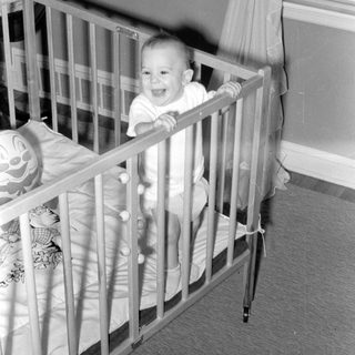 Baby smiling in a crib