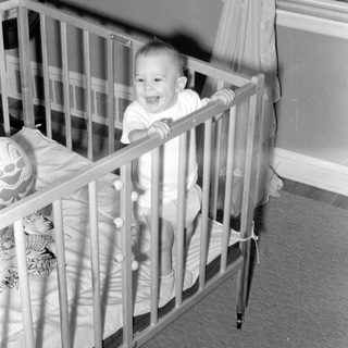 Baby smiling in a crib