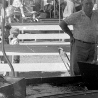 Children riding a boat attraction at an amusement park.