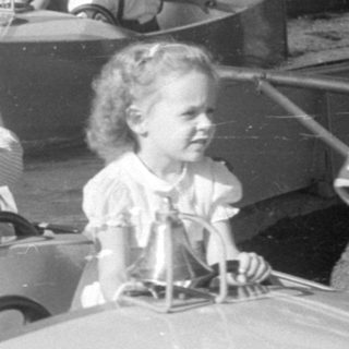 Children riding a boat attraction at an amusement park.