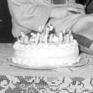 Family group with a cake and child in costume.