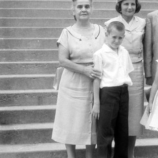 Family group posing on wide stone stairs.