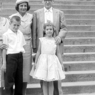 Family group posing on wide stone stairs.