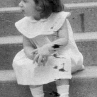 Woman and two children on wide stone stairs.