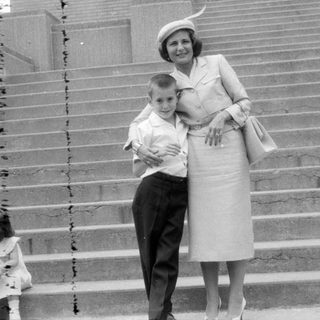 Woman and two children on wide stone stairs.