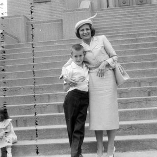 Woman and two children on wide stone stairs.