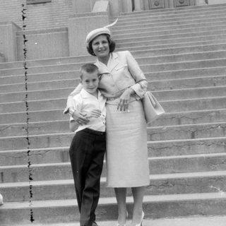 Woman and two children on wide stone stairs.
