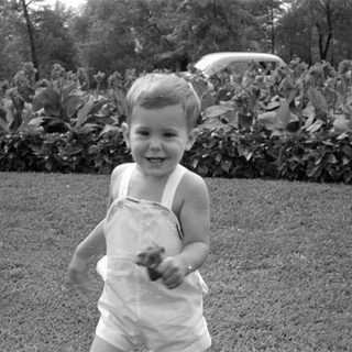 Upside-down black and white photo of a young child.