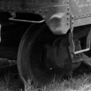 Vintage ACL automobile freight cars on a track.