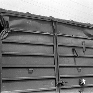 Damaged metal railcar doors with ACL lettering.