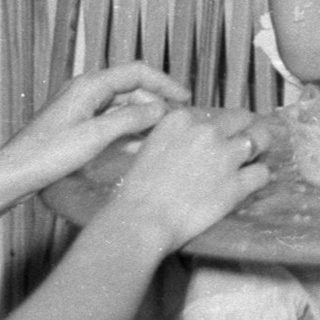 Toddler in high chair with food on face.