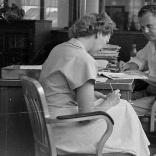Man and woman at a desk in an office.