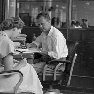 Man and woman at a desk in an office.