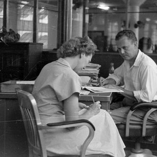Man and woman at a desk in an office.
