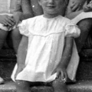 Six children posed on concrete stairs.