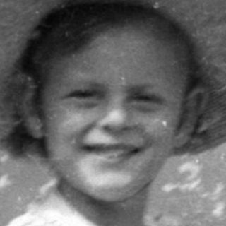 Child in a sun hat with a doll.