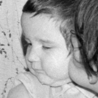 Two young children sitting on a sofa.