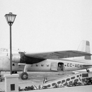 Propeller airplane EC-AEH on a tarmac.