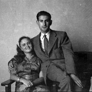 Portrait of a man in a suit and woman in a dress.