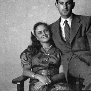 Portrait of a man in a suit and woman in a dress.