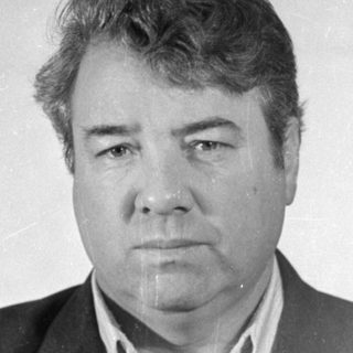 Black and white portrait of a man in a suit.