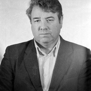 Black and white portrait of a man in a suit.