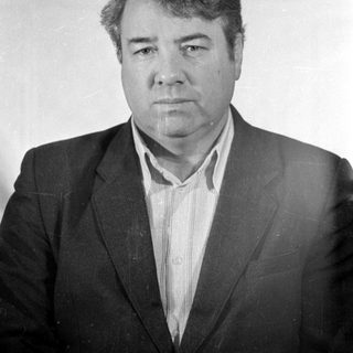 Black and white portrait of a man in a suit.