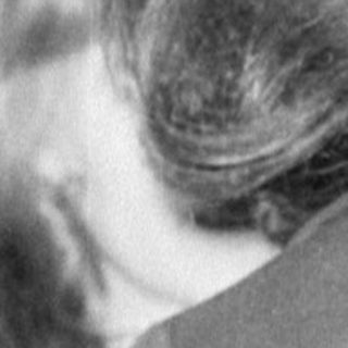 Rear view of a person sitting at a table.