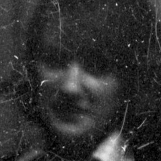 Scratched black and white portrait of a person.