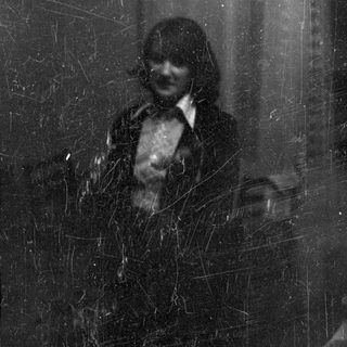 Scratched black and white portrait of a person.