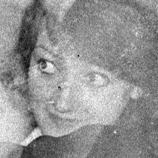 Double-exposure portrait of two people in dark clothing.