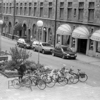 Street view with Orion Fur shops and parked bicycles.