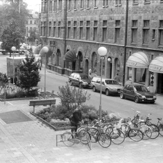 Street view with Orion Fur shops and parked bicycles.