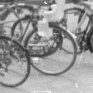 Street view with Orion Fur shops and parked bicycles.