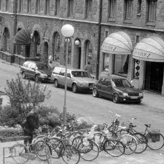 Street view with Orion Fur shops and parked bicycles.