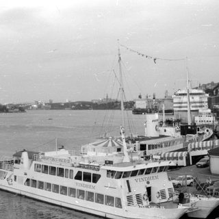 Passenger boat VINDHEM docked in a harbor.