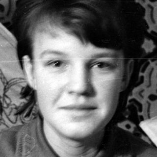 Two young women posing against a patterned backdrop.