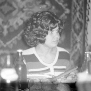 Man and woman at a table with bottles.