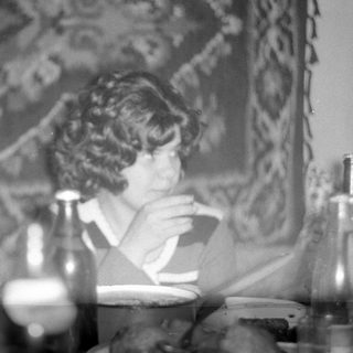 Man and woman sitting at a table indoors.