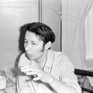 Man sitting at a table with glassware.