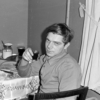 Two men sitting at a table with drinks.